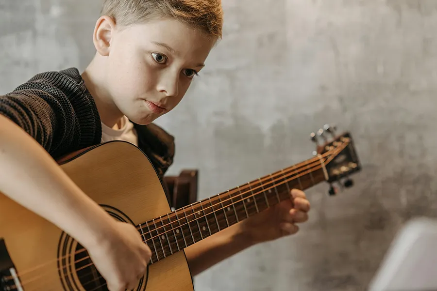 Child learning guitar